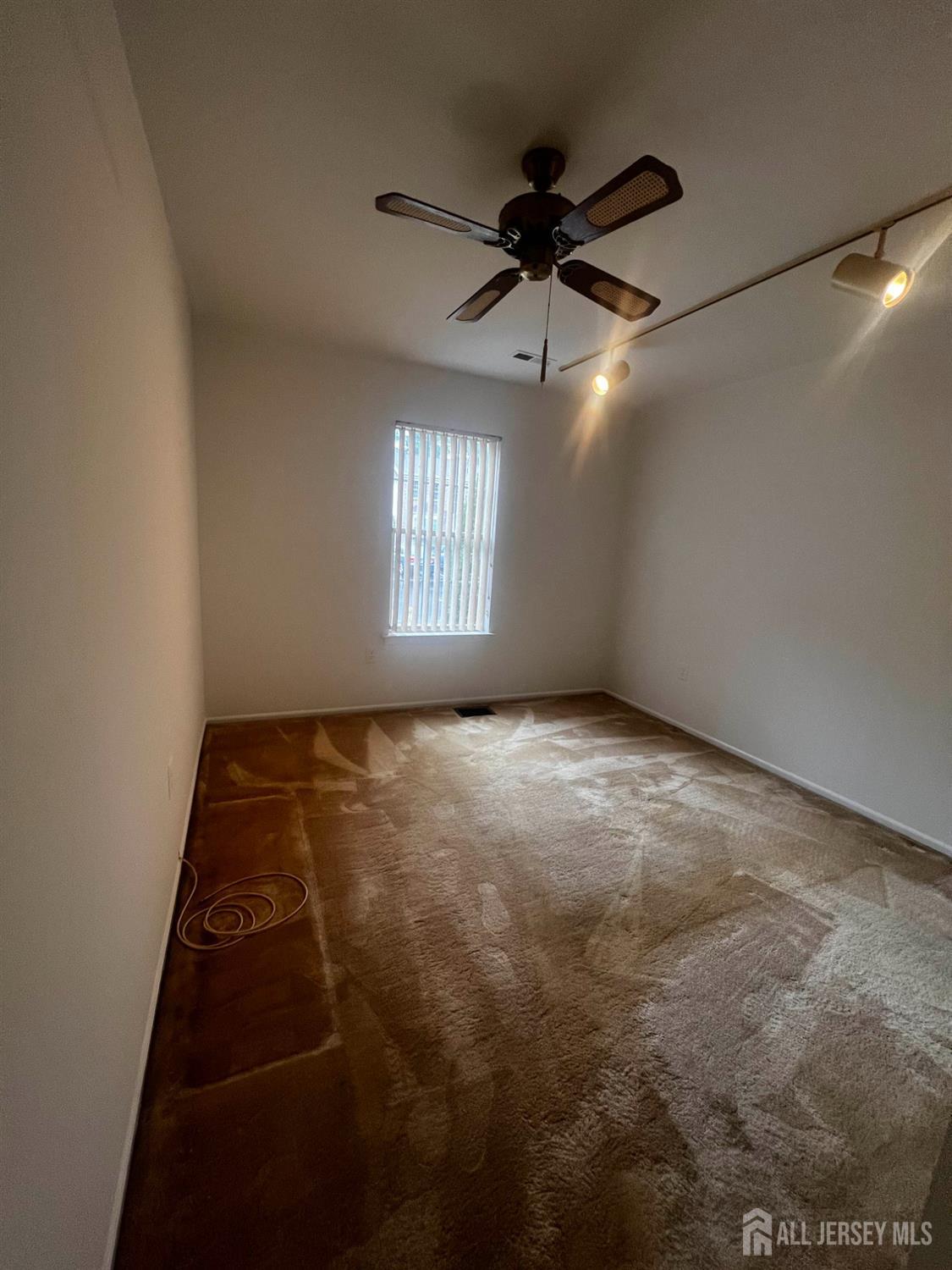143 Archery Court Old Bridge, NJ 08857 - Photo 24 of 29 en empty room with windows and ceiling fan view