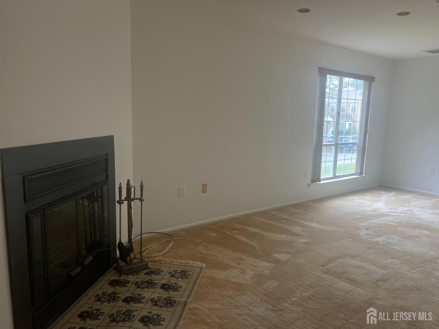 143 Archery Court Old Bridge, NJ 08857 - Photo 6 of 29 a view of an empty room with wooden floor and a window