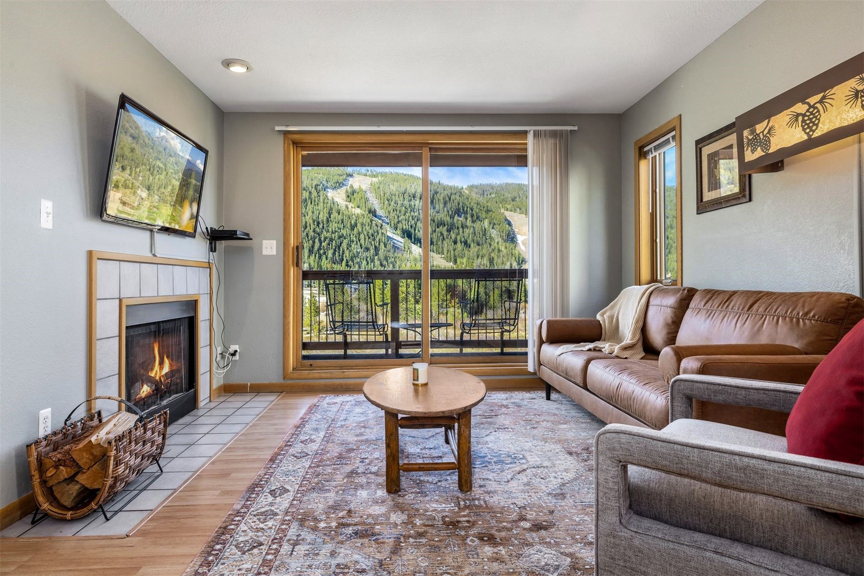 a living room with furniture a fireplace and a flat screen tv