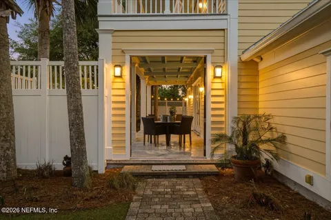 a view of a porch with a table and chairs and potted plants