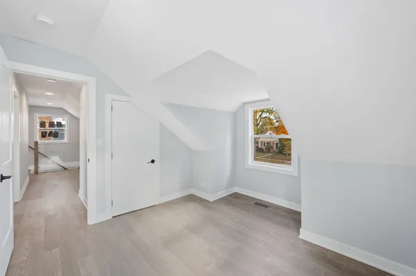 an empty room with windows and closet