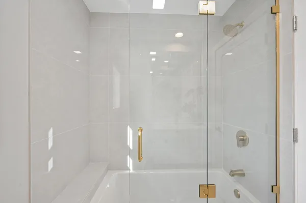 a bathroom with a shower and bathtub