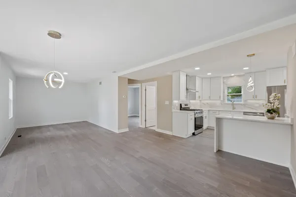 a view of a kitchen with sink and cabinets