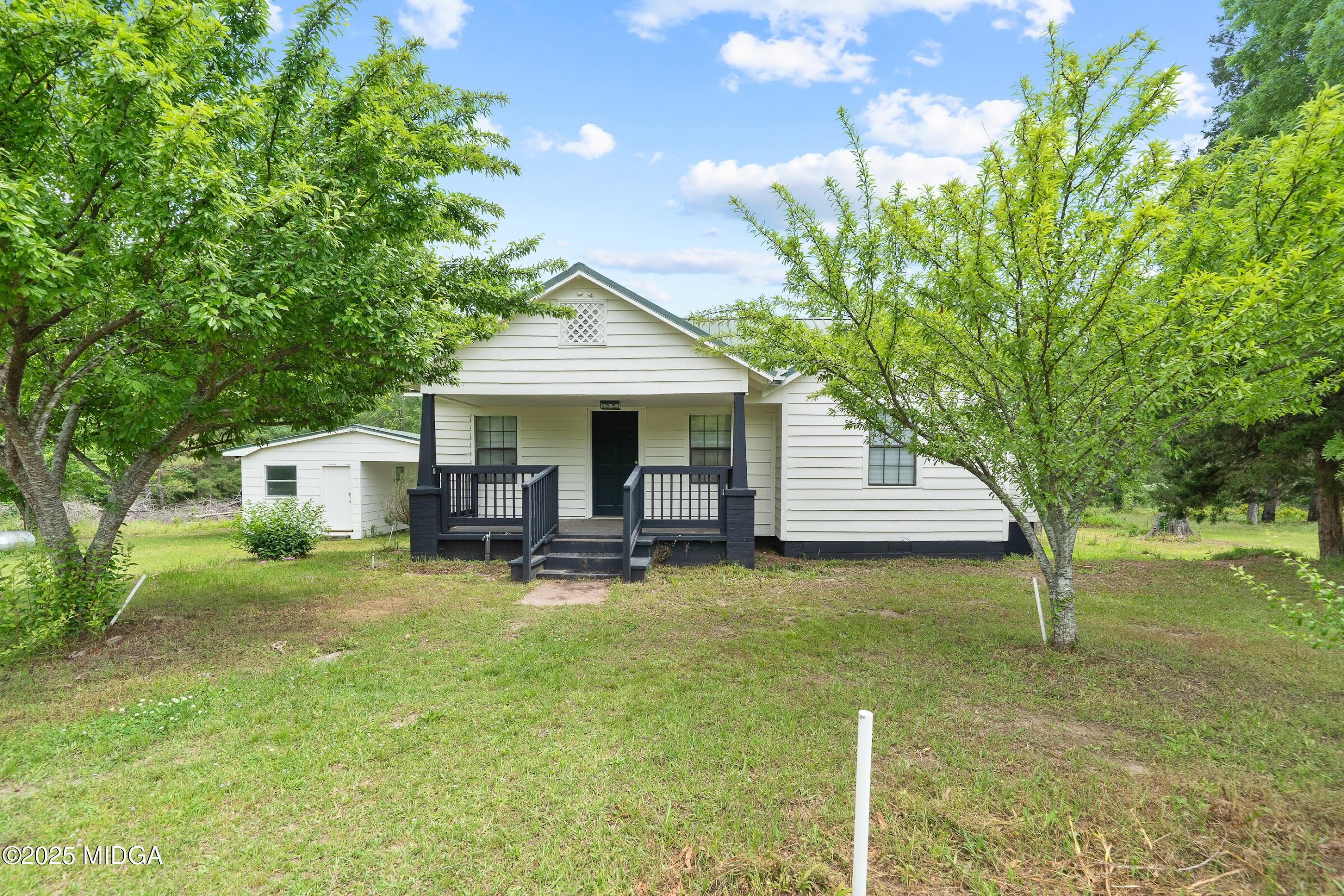 a view of a house with backyard porch and sitting area