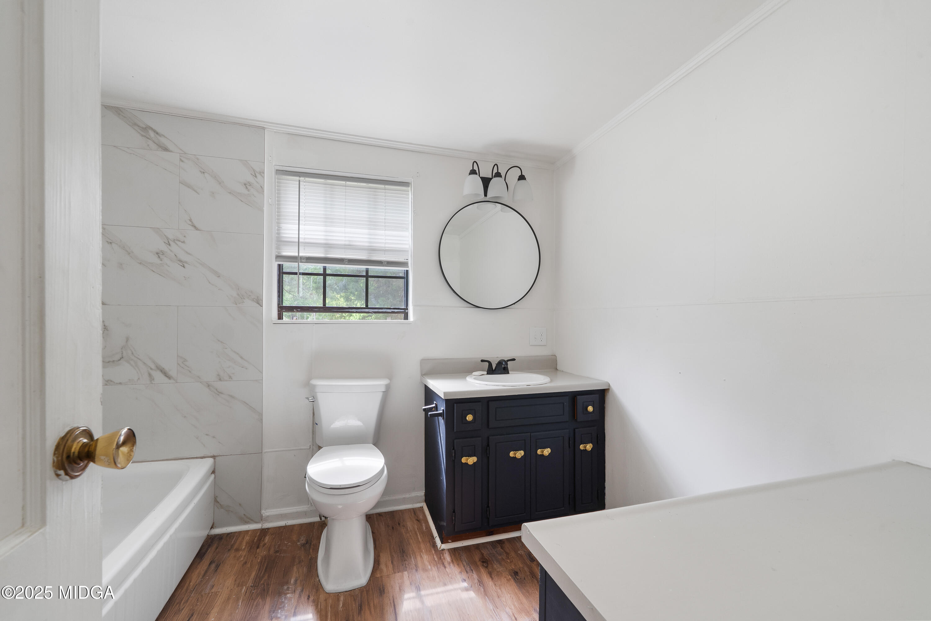 1512 Highway 22 Haddock, GA 31033 - Photo 14 of 32 a bathroom with a toilet a sink and a mirror