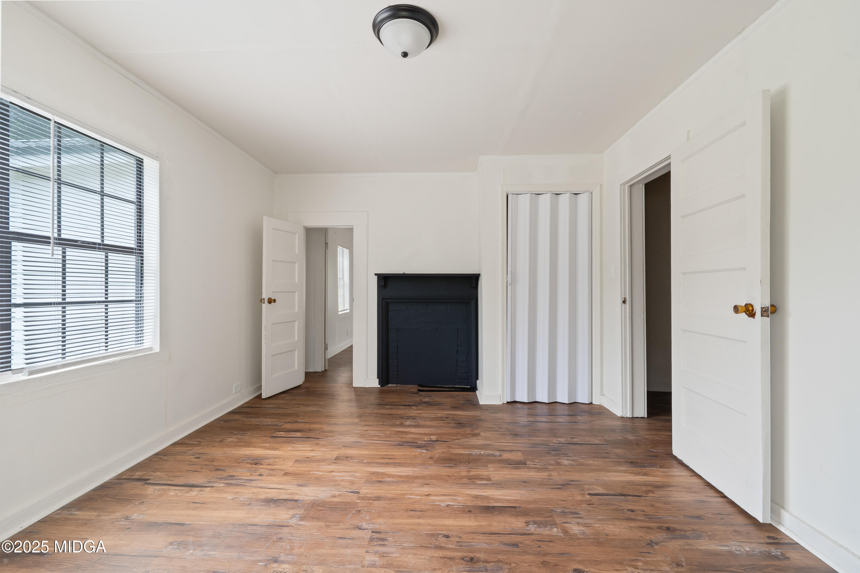 1512 Highway 22 Haddock, GA 31033 - Photo 17 of 32 a view of an empty room with wooden floor and a window
