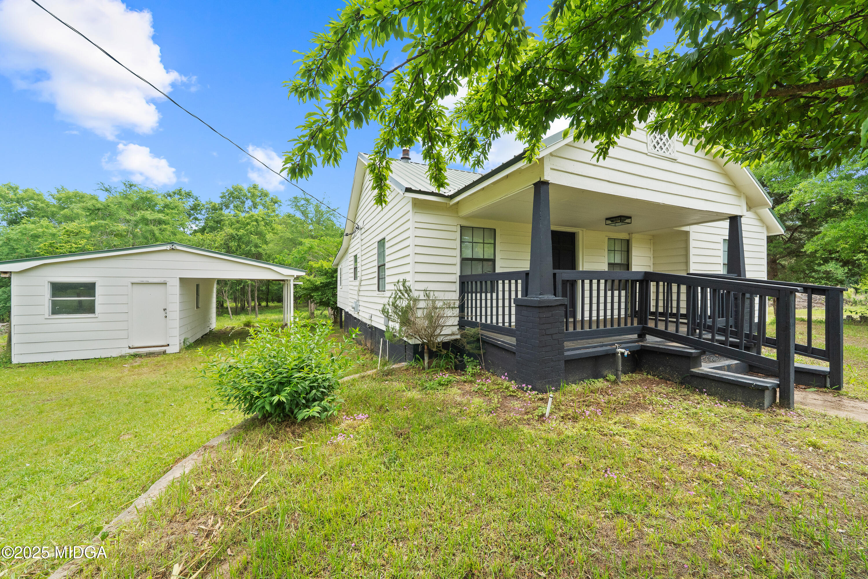 1512 Highway 22 Haddock, GA 31033 - Photo 21 of 32 a view of a house with a yard chairs and a table under an umbrella
