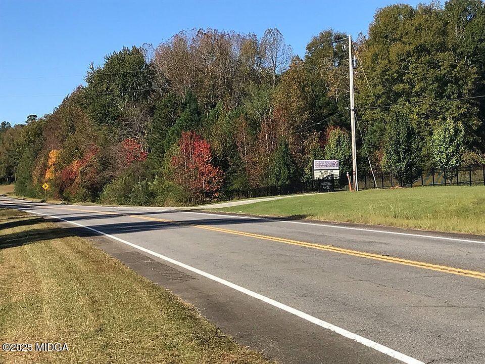 1512 Highway 22 Haddock, GA 31033 - Photo 26 of 32 a view of a swimming pool and trees in the background