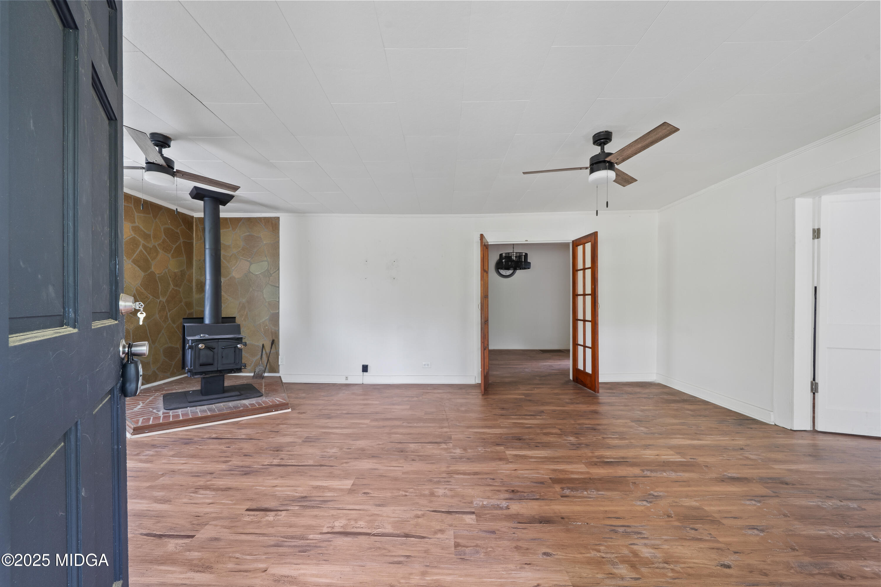 1512 Highway 22 Haddock, GA 31033 - Photo 3 of 32 a view of a livingroom with a fireplace and wooden floor