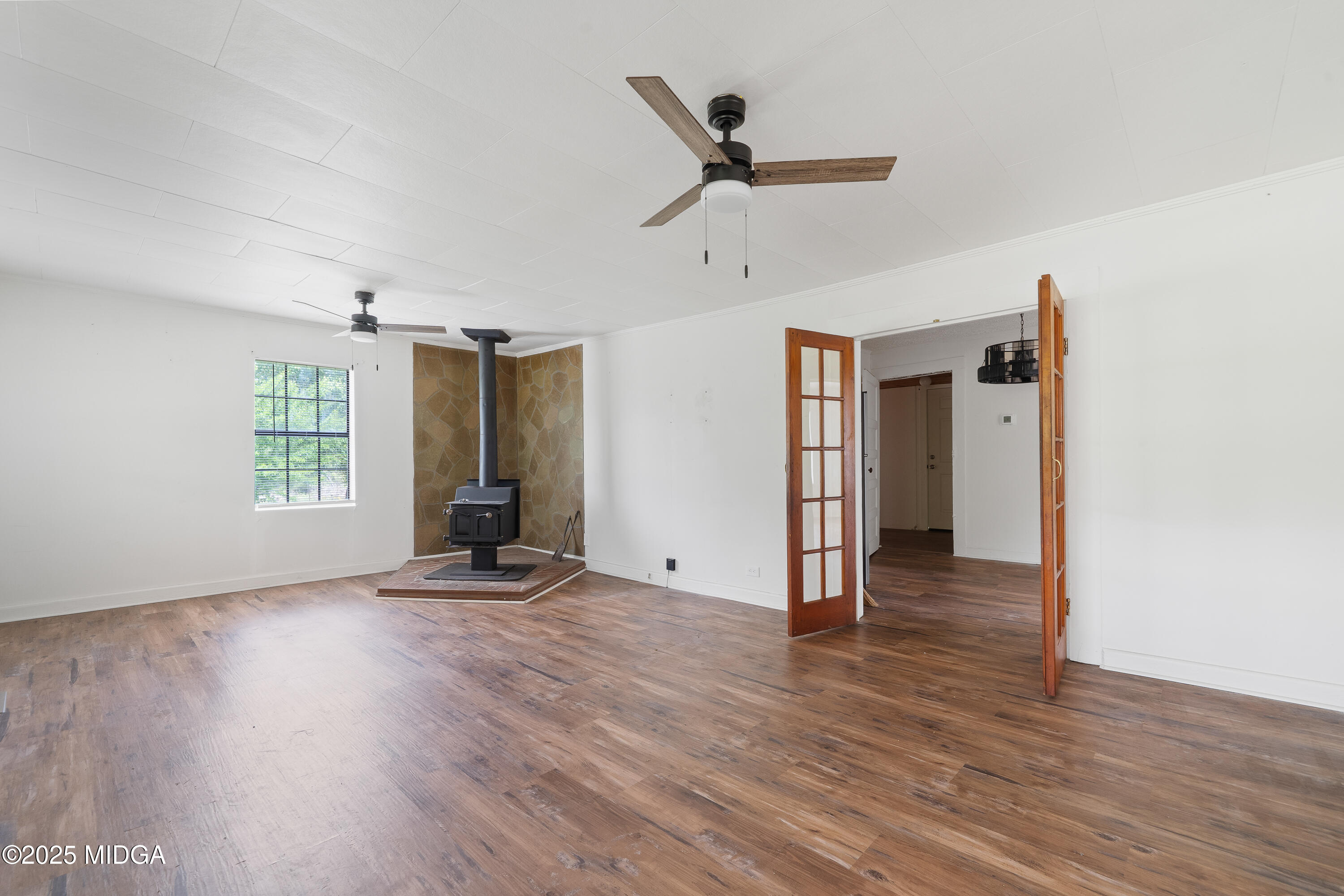 1512 Highway 22 Haddock, GA 31033 - Photo 4 of 32 an empty room with wooden floor and windows
