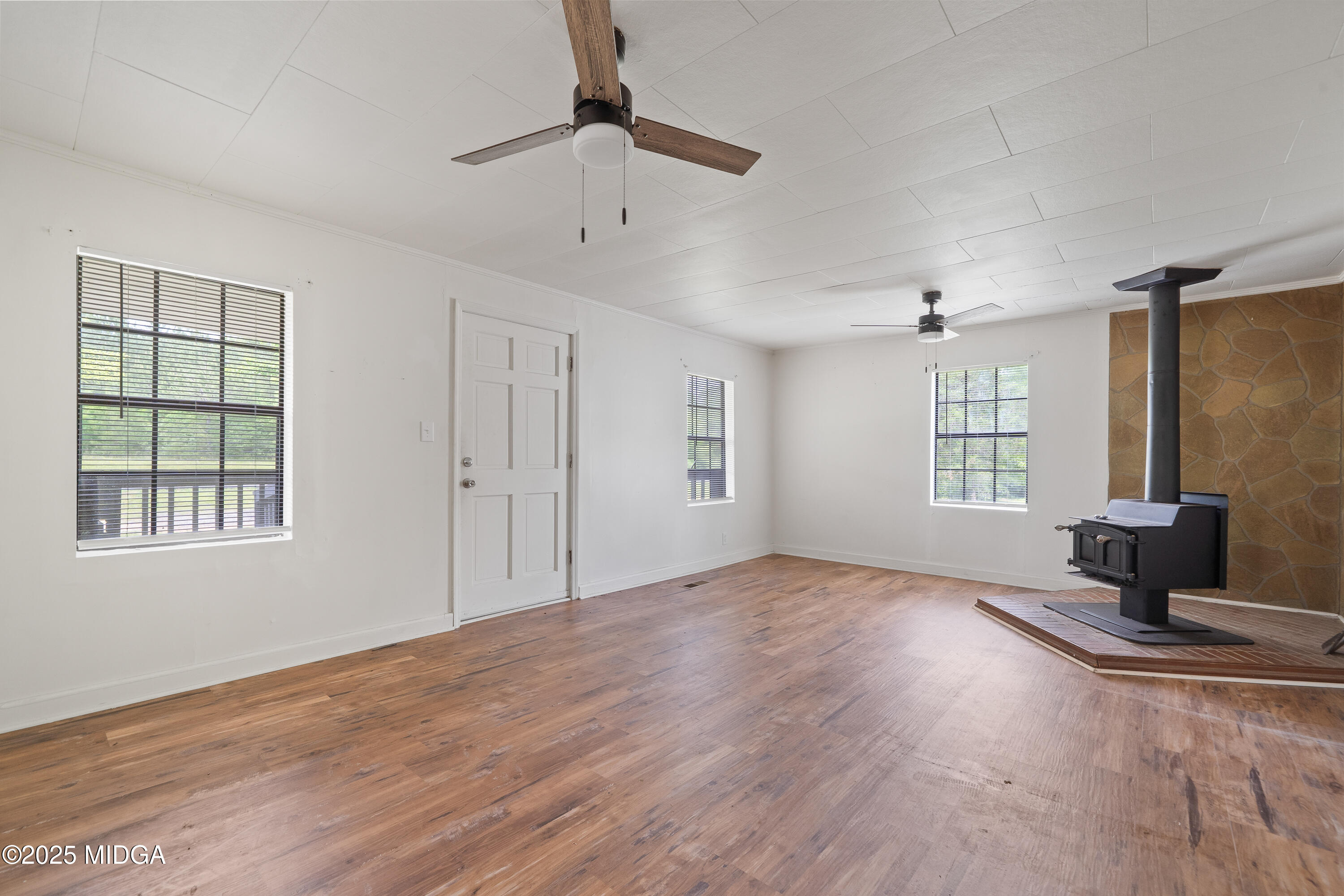 1512 Highway 22 Haddock, GA 31033 - Photo 5 of 32 wooden floor in an empty room with a window