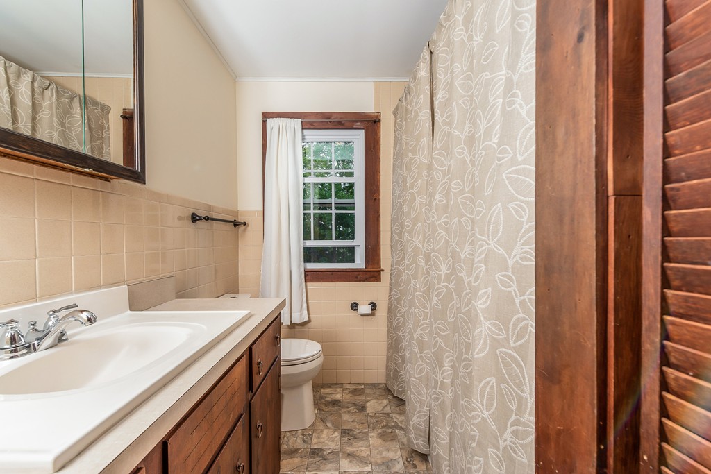 6-a&b Proctor Hill Road Hollis, NH 03049 - Photo 27 of 30 a bathroom with a sink a toilet and shower curtain
