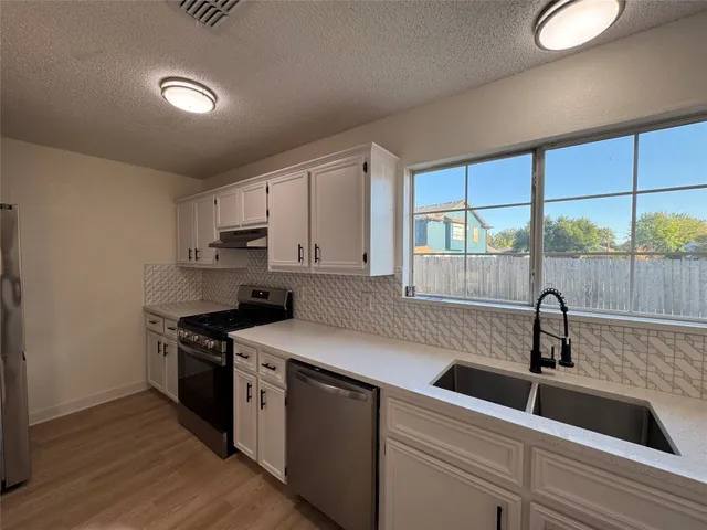 a kitchen that has a sink and a stove