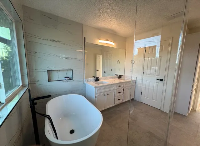 a bathroom with a walk in closet and a shower