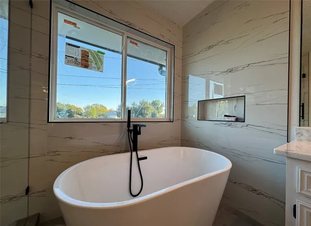 a bathroom with a double vanity sink mirror and shower