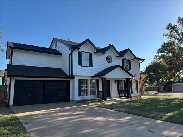 a front view of a house with a garden and yard