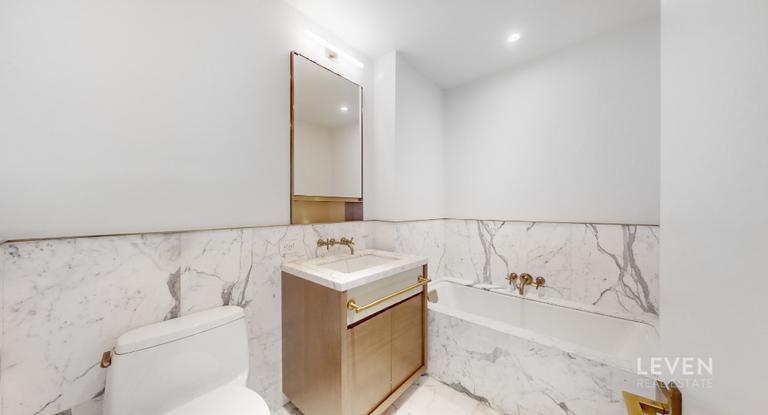 305 East 51st Street, Unit RU5A Manhattan, NY 10022 - Photo 11 of 15 a en suite bathroom with a bathtub and sink