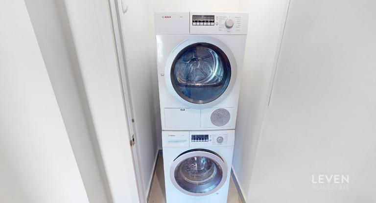 305 East 51st Street, Unit RU5A Manhattan, NY 10022 - Photo 12 of 15 a utility room with dryer and washer