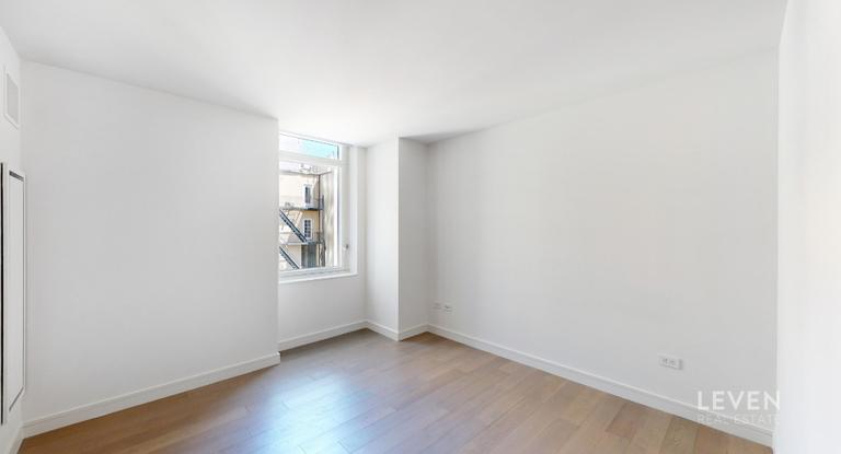 305 East 51st Street, Unit RU5A Manhattan, NY 10022 - Photo 9 of 15 a view of an empty room and window