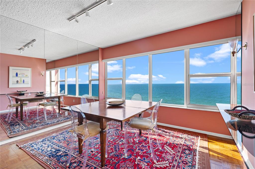 Undisclosed Address Longboat Key, FL 34228 - Photo 12 of 68 a living room with furniture a rug and a floor to ceiling window