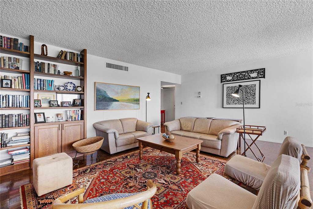 601 Longboat Club Road, Unit 902S Longboat Key, FL 34228 - Photo 12 of 65 a living room with furniture and a book shelf