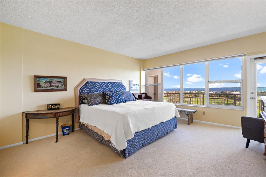 601 Longboat Club Road, Unit 902S Longboat Key, FL 34228 - Photo 14 of 65 a spacious bedroom with a bed and a large window