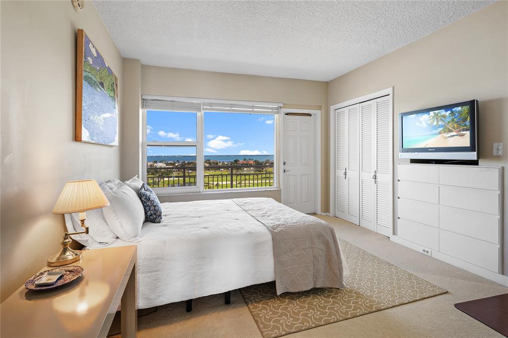 Undisclosed Address Longboat Key, FL 34228 - Photo 21 of 68 a bedroom with a bed and wooden floor