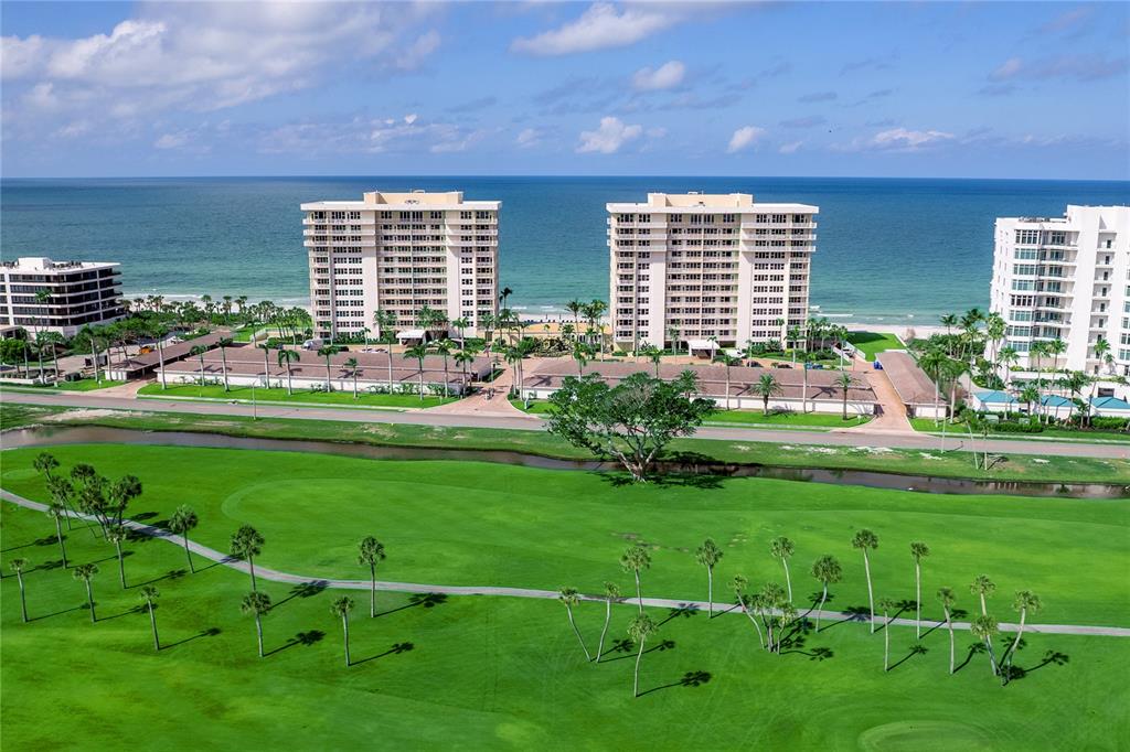 601 Longboat Club Road, Unit 902S Longboat Key, FL 34228 - Photo 34 of 65 a swimming pool with outdoor seating and yard