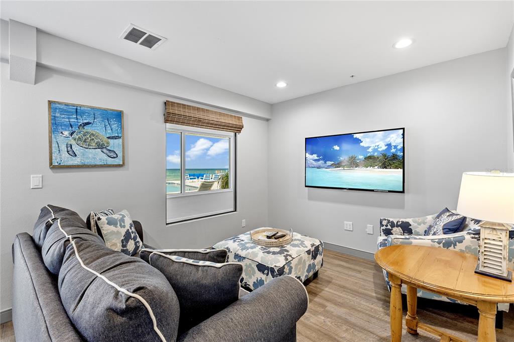 601 Longboat Club Road, Unit 902S Longboat Key, FL 34228 - Photo 42 of 65 a living room with furniture and a flat screen tv