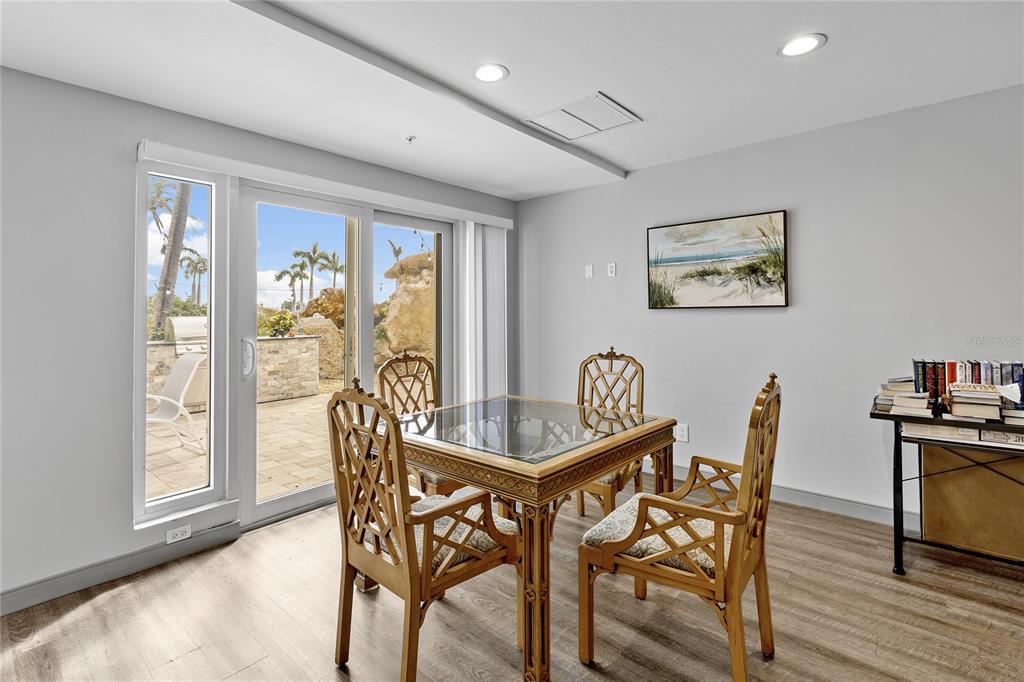 601 Longboat Club Road, Unit 902S Longboat Key, FL 34228 - Photo 46 of 65 a view of a dining room with furniture large window and wooden floor