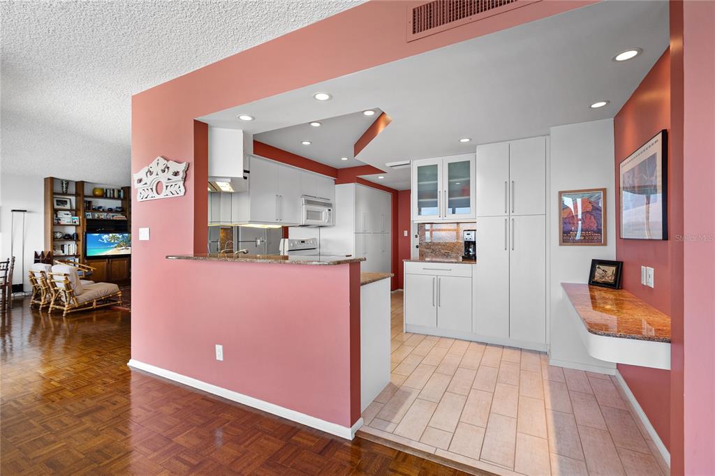 Undisclosed Address Longboat Key, FL 34228 - Photo 6 of 68 a open kitchen with cabinets and wooden floor