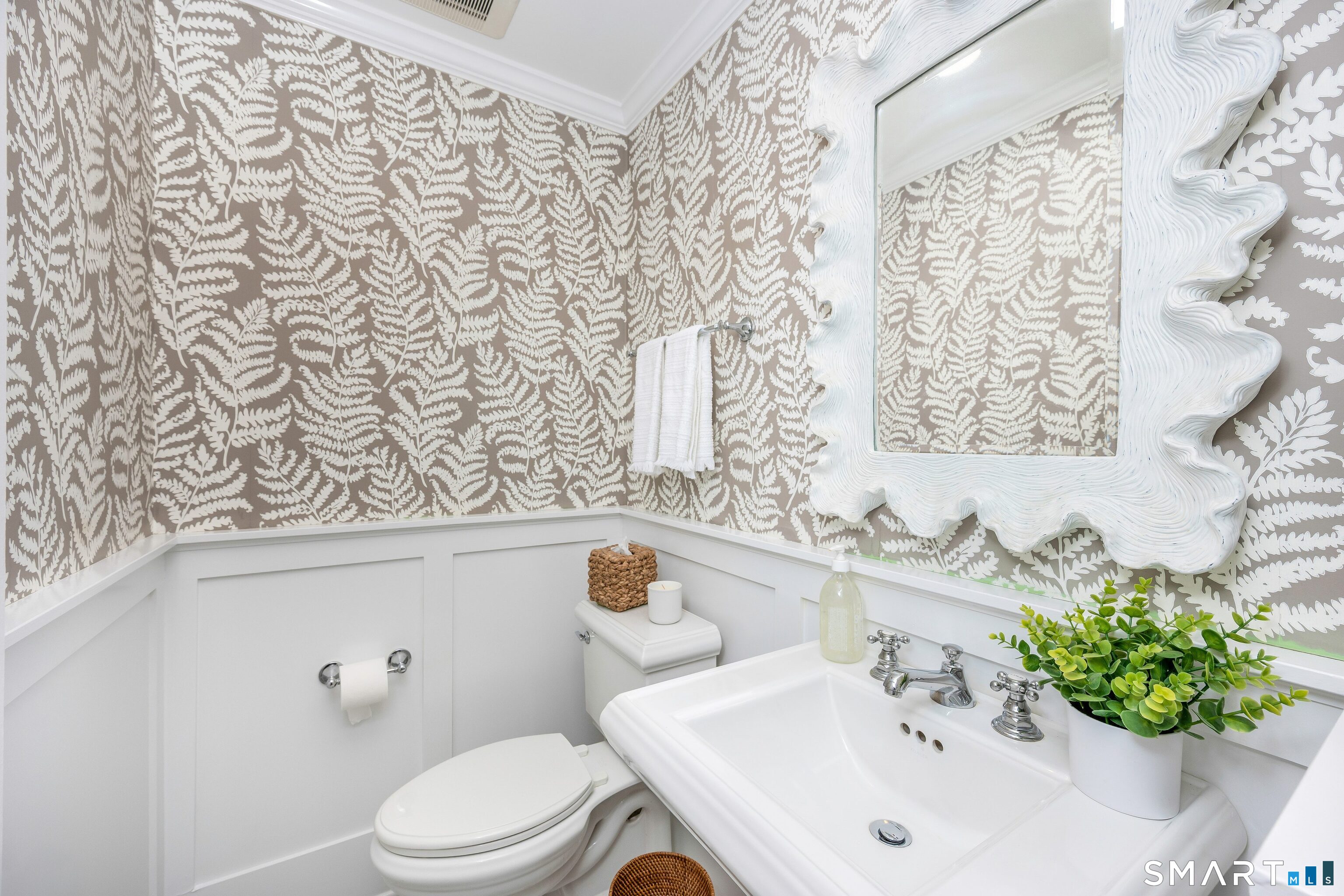 27 Point O Woods Road South Darien, CT 06820 - Photo 12 of 32 a bathroom with a sink a toilet and a mirror