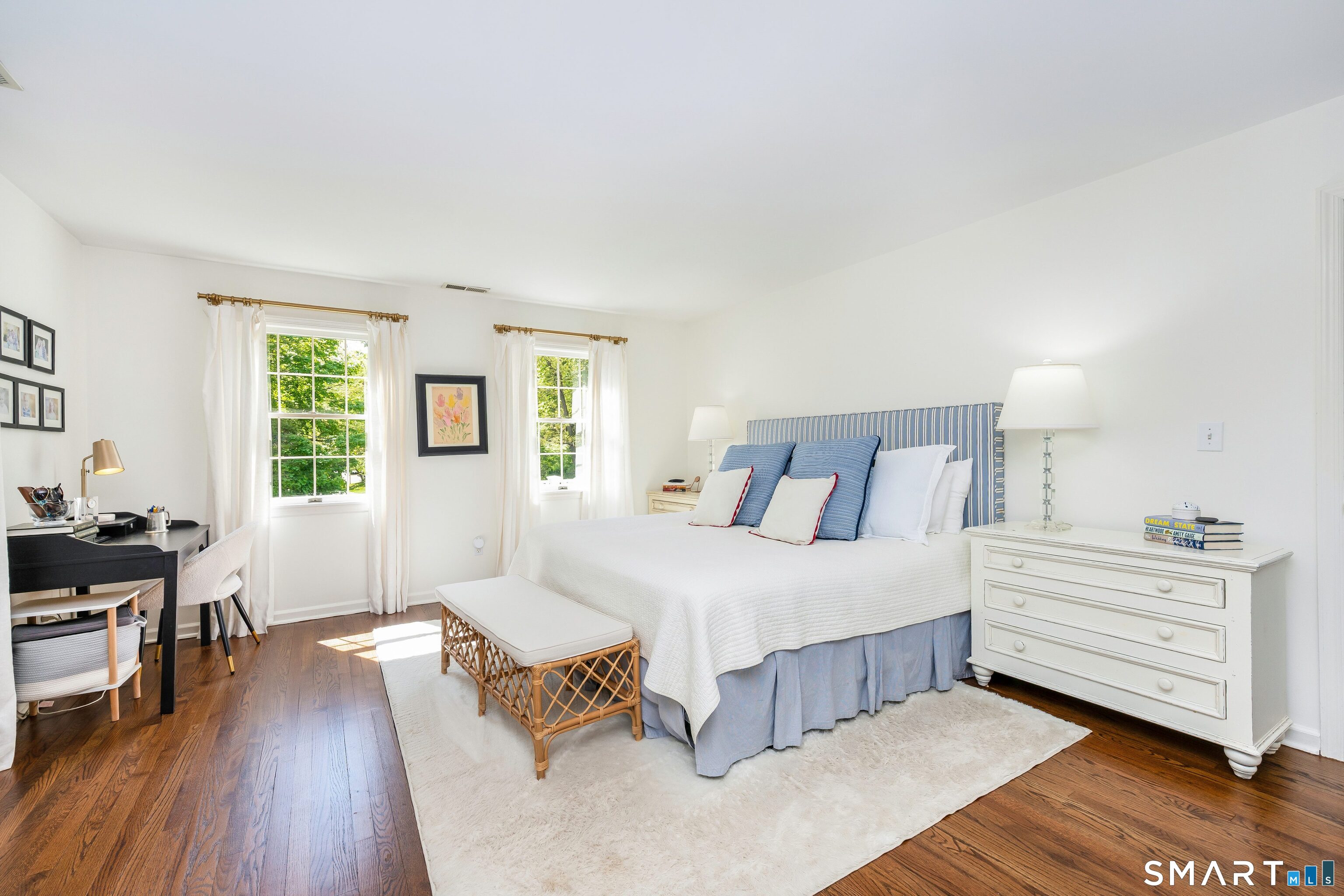 27 Point O Woods Road South Darien, CT 06820 - Photo 16 of 32 a spacious bedroom with a bed and a table in it