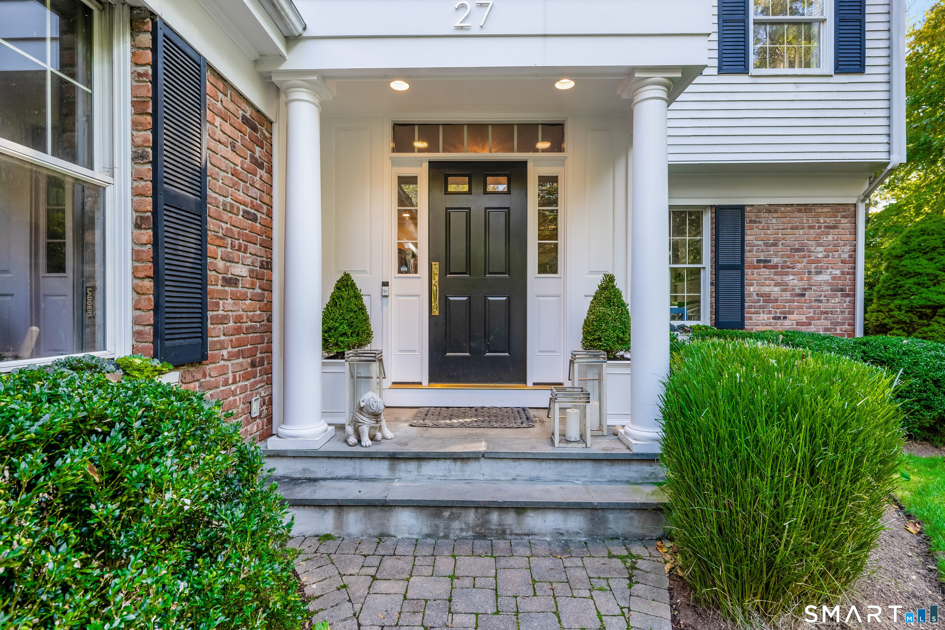 27 Point O Woods Road South Darien, CT 06820 - Photo 2 of 32 a front view of a house with garden