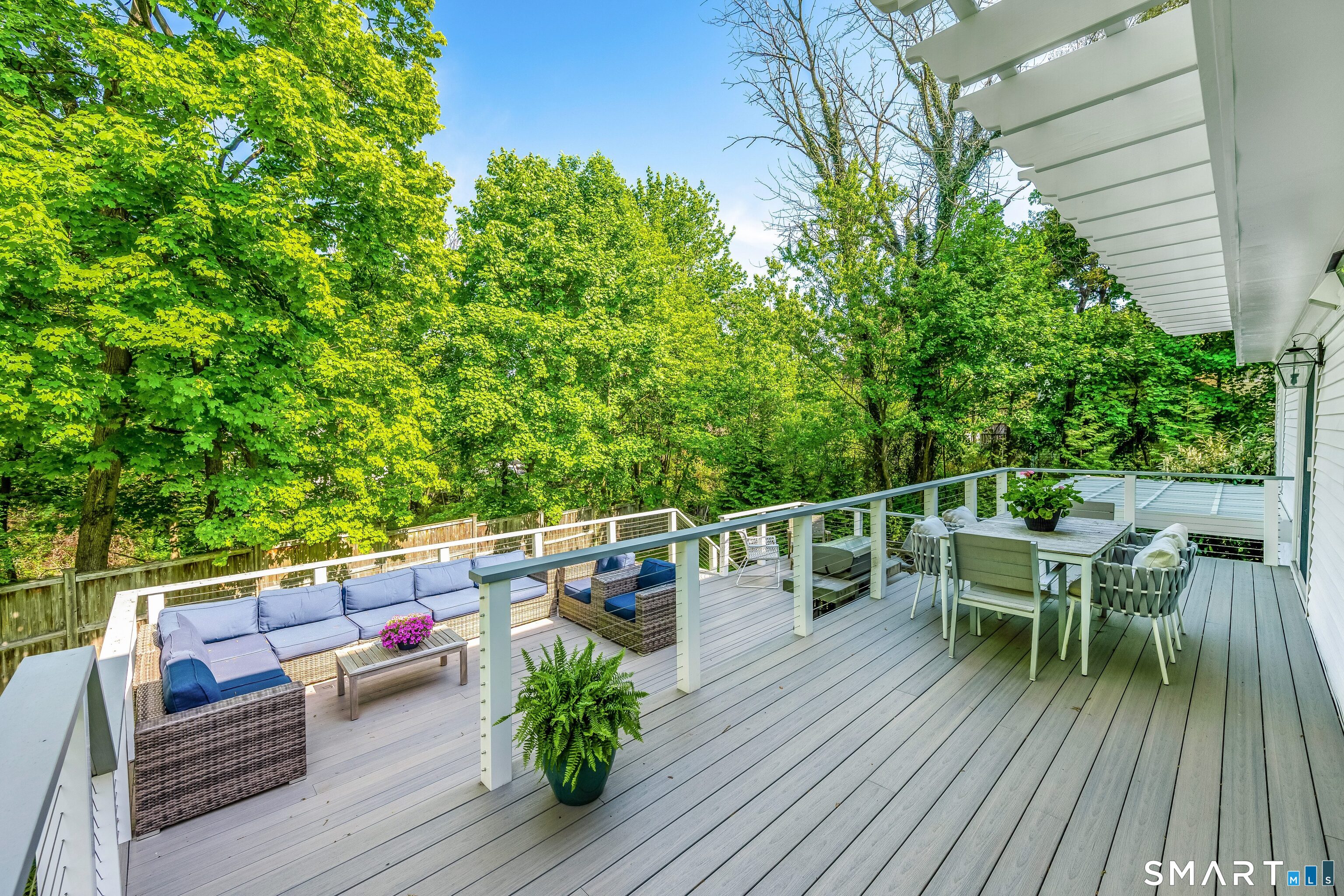 27 Point O Woods Road South Darien, CT 06820 - Photo 27 of 32 a view of roof deck with dining table and chairs with wooden floor