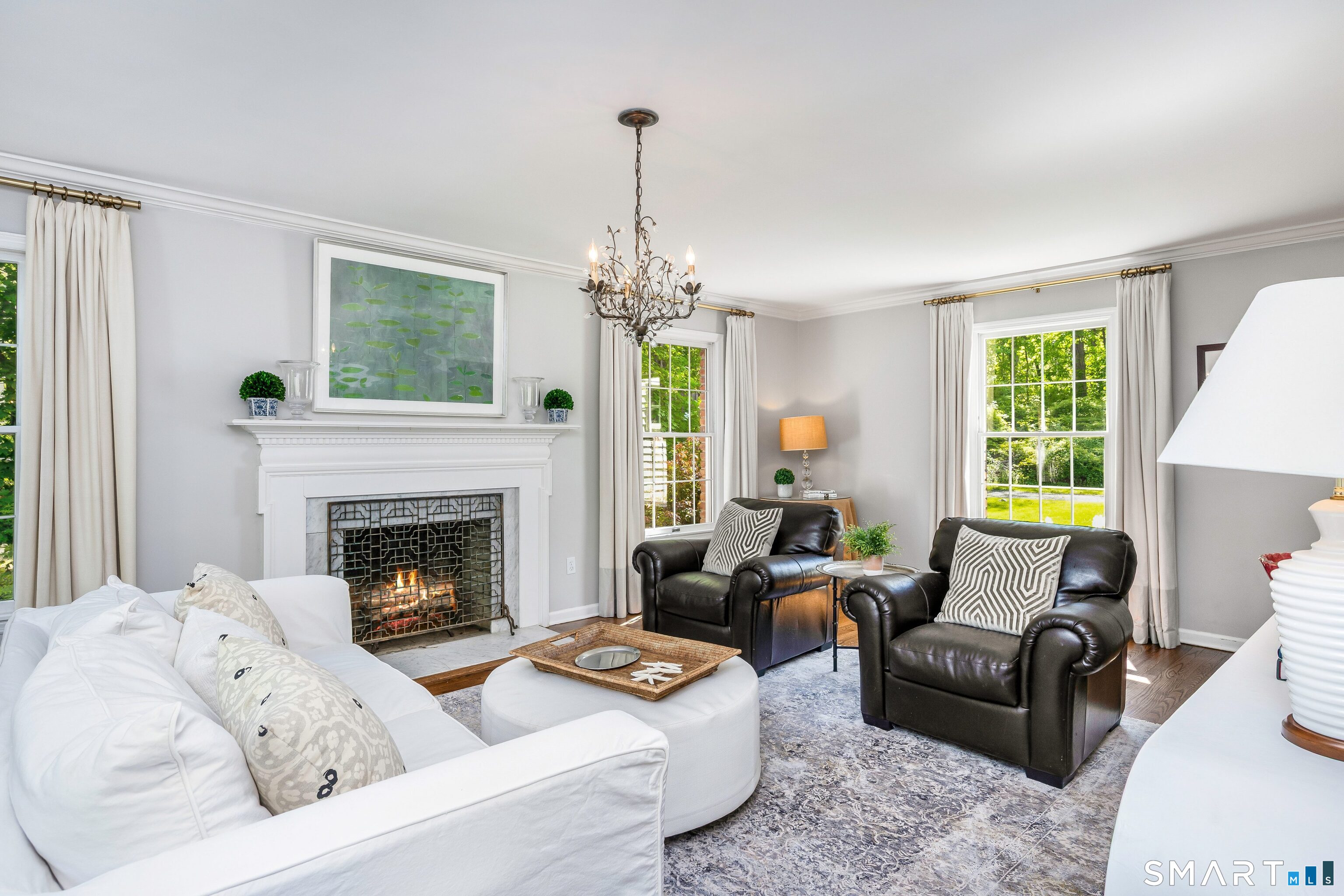 27 Point O Woods Road South Darien, CT 06820 - Photo 4 of 32 a living room with furniture a fireplace and a chandelier