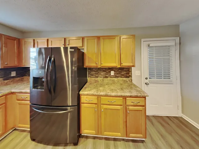 a kitchen with a refrigerator a stove and a sink
