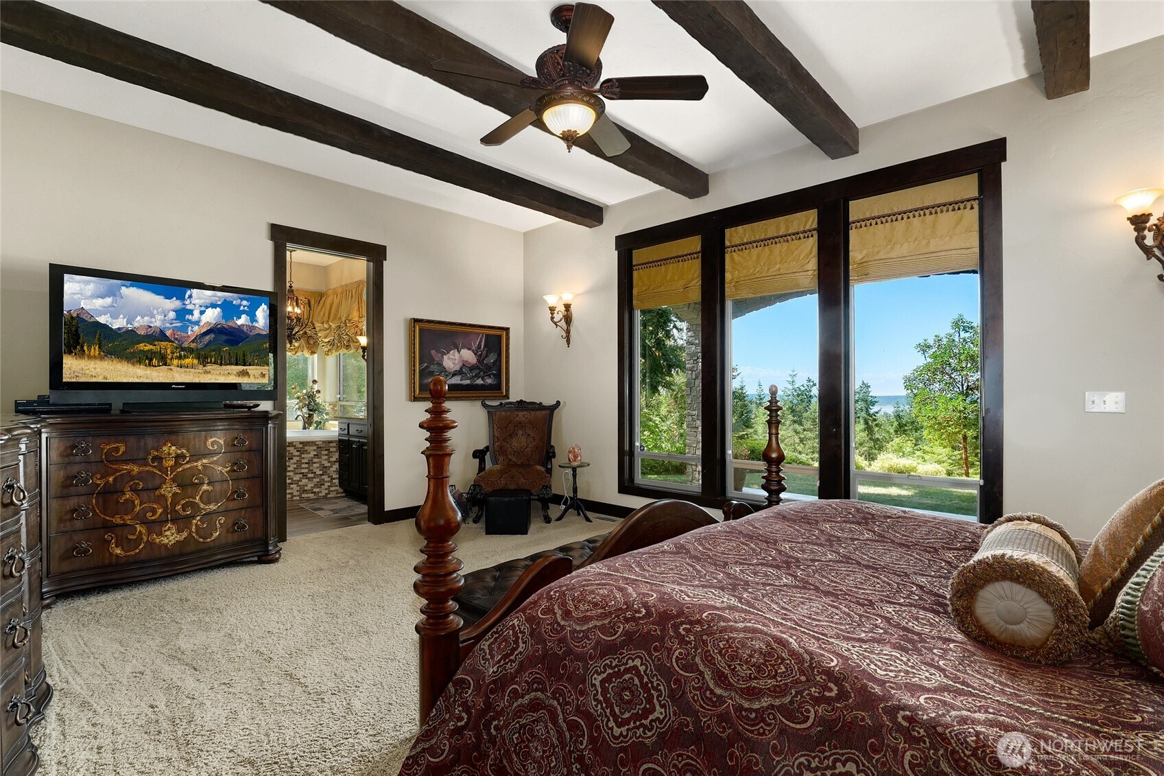 67 North Gilbertson Road Camano Island, WA 98282 - Photo 18 of 40 a bedroom with a bed a flat screen tv and a large window