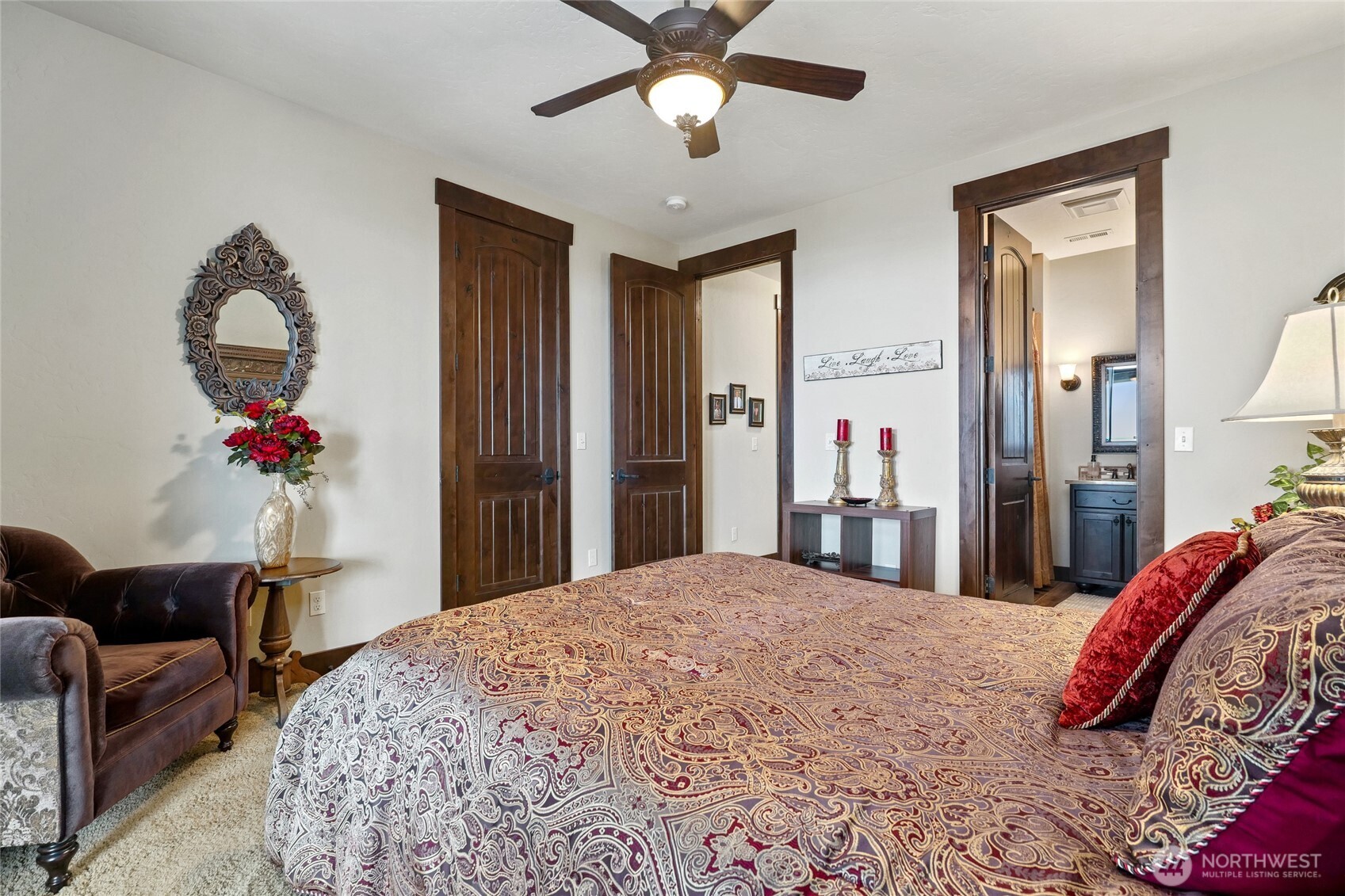 67 North Gilbertson Road Camano Island, WA 98282 - Photo 30 of 40 a bedroom with a bed and a chandelier