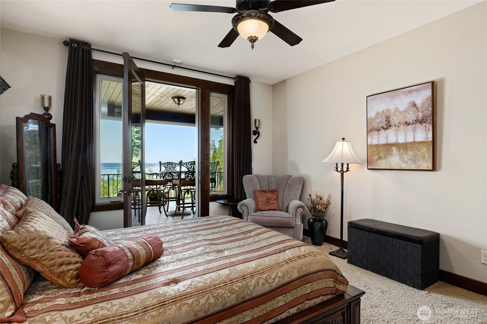 67 North Gilbertson Road Camano Island, WA 98282 - Photo 32 of 40 a bedroom with a bed and glass windows