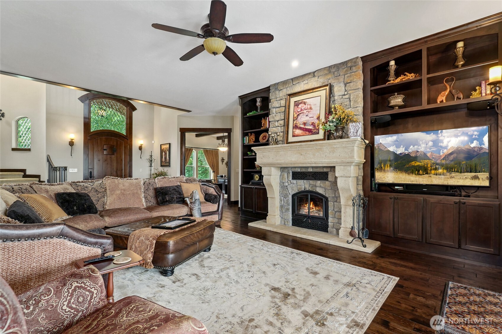 67 North Gilbertson Road Camano Island, WA 98282 - Photo 8 of 40 a living room with furniture a flat screen tv and a fireplace