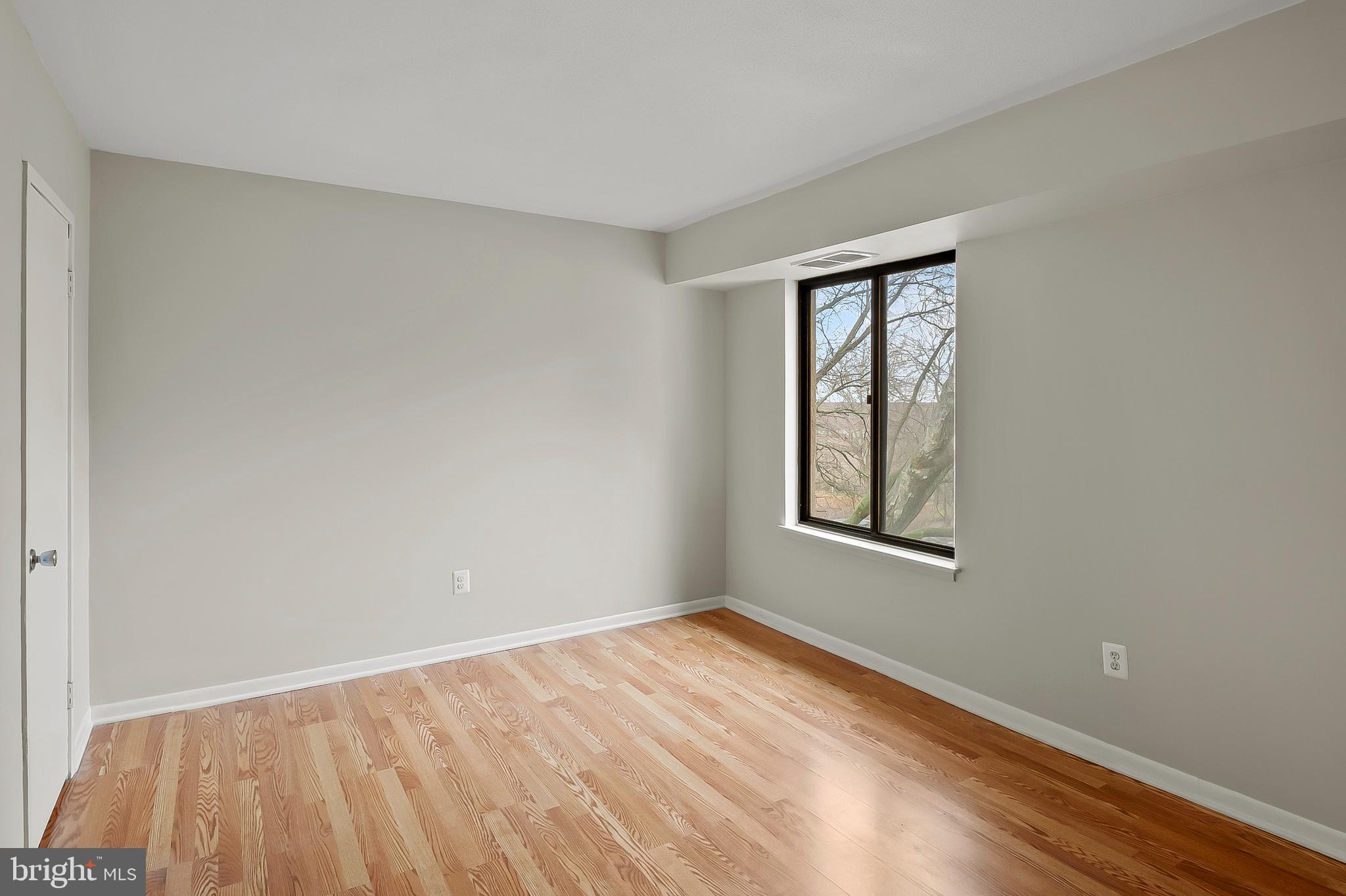 5870 Thunder Hill Road, Unit C2 Columbia, MD 21045 - Photo 11 of 23 a view of an empty room with wooden floor and a window