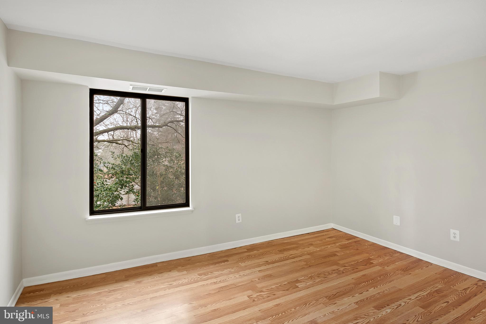 5870 Thunder Hill Road, Unit C2 Columbia, MD 21045 - Photo 12 of 23 a view of an empty room with wooden floor and a window