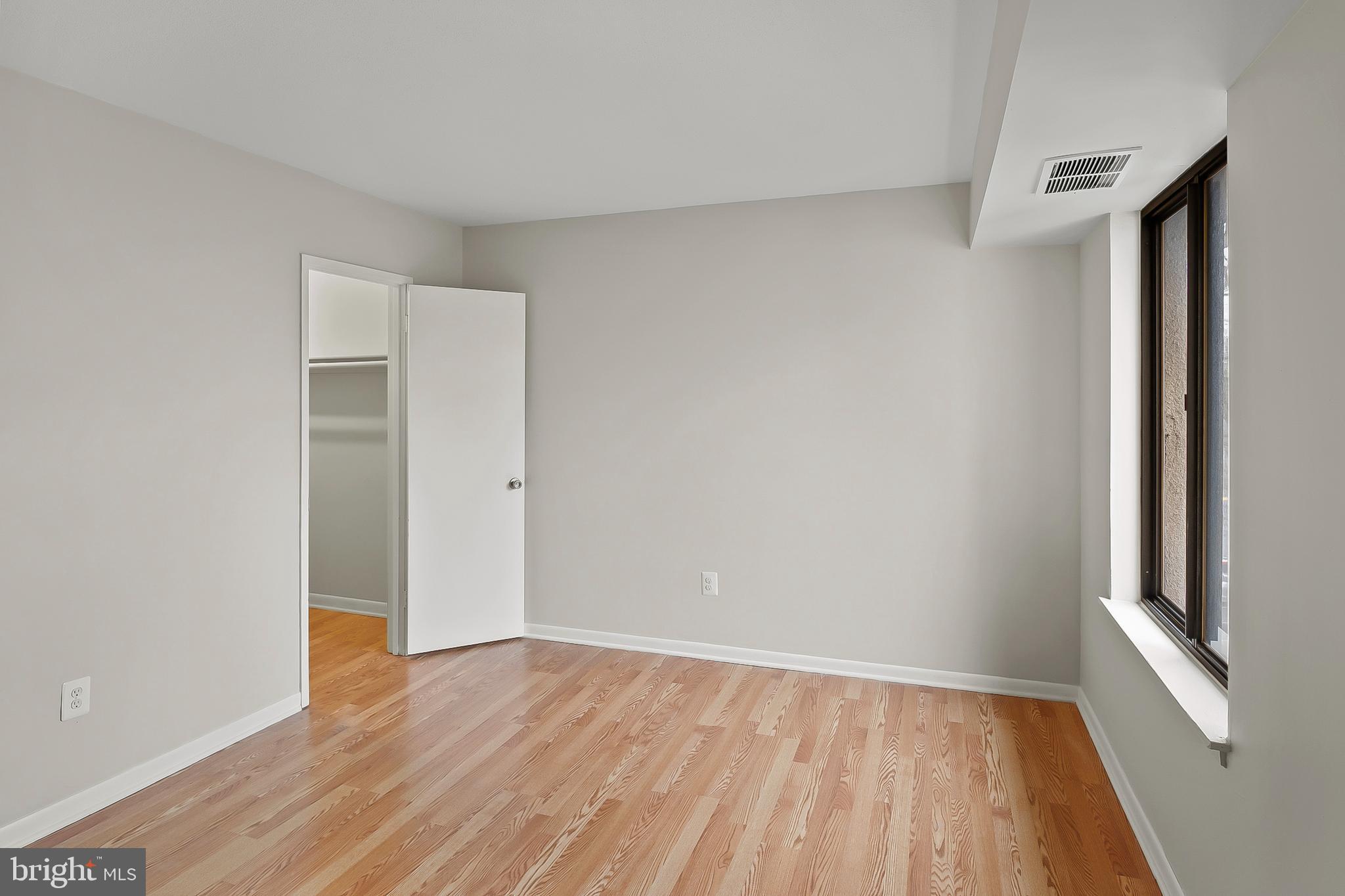 5870 Thunder Hill Road, Unit C2 Columbia, MD 21045 - Photo 14 of 23 a view of an empty room with wooden floor and a window