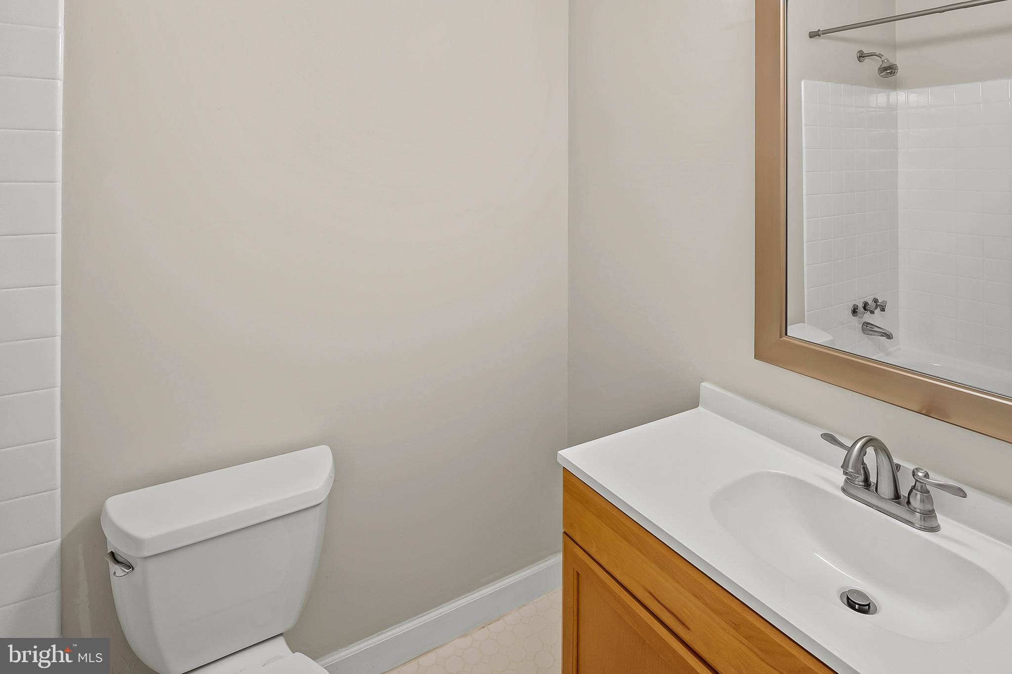 5870 Thunder Hill Road, Unit C2 Columbia, MD 21045 - Photo 16 of 23 a bathroom with a sink a toilet and a mirror