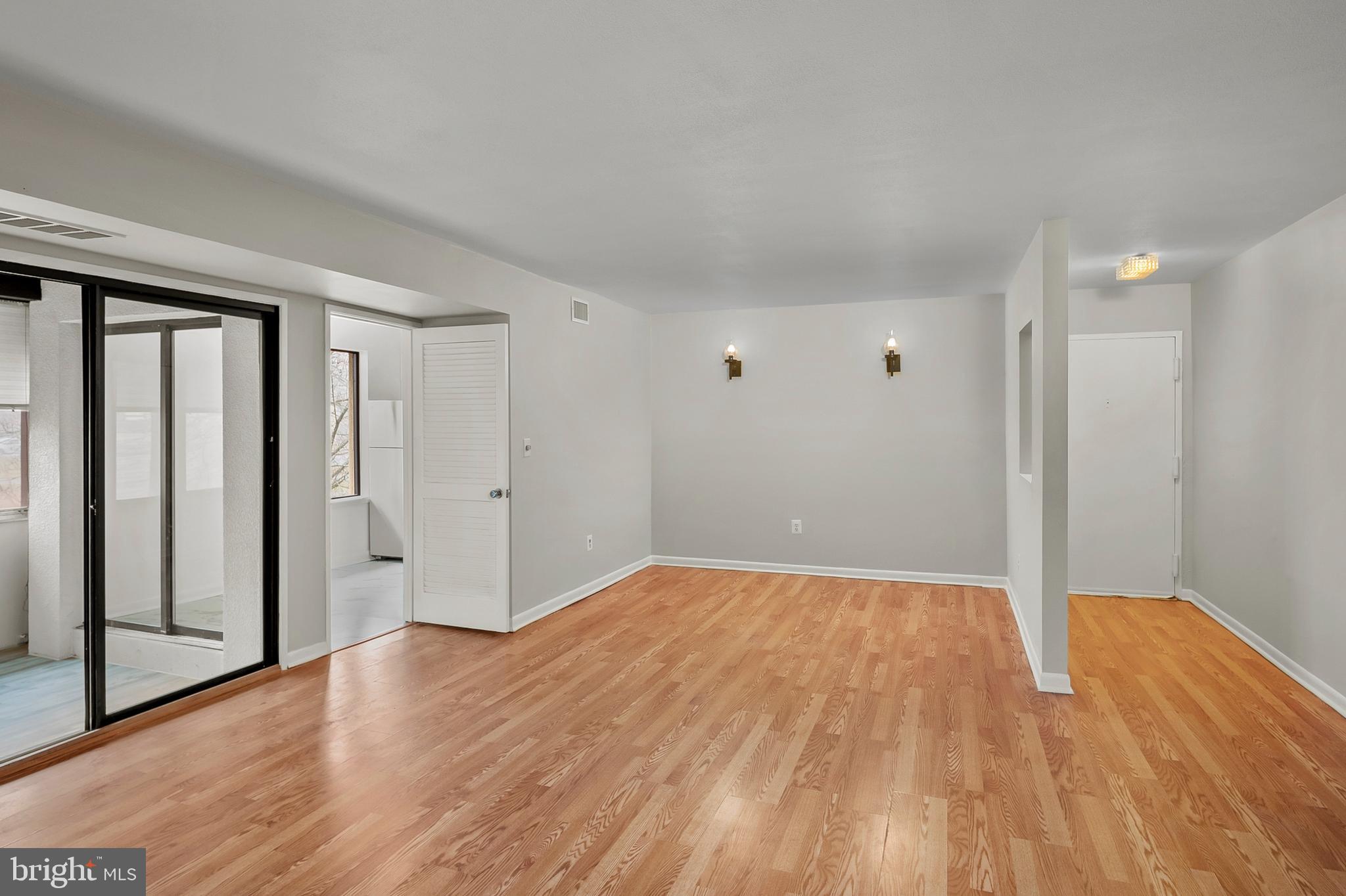 5870 Thunder Hill Road, Unit C2 Columbia, MD 21045 - Photo 2 of 23 wooden floor in an empty room with a window