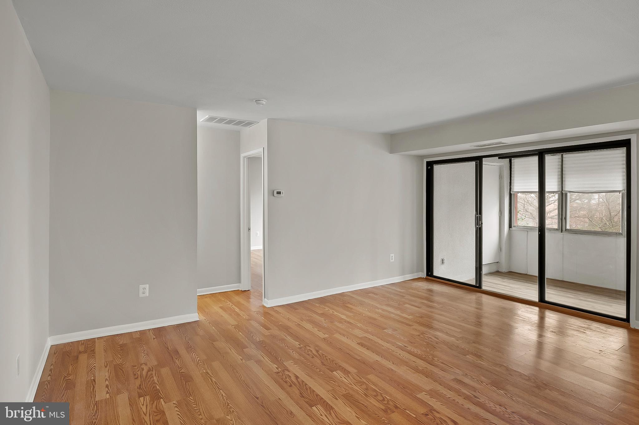 5870 Thunder Hill Road, Unit C2 Columbia, MD 21045 - Photo 4 of 23 a view of empty room with wooden floor and fan