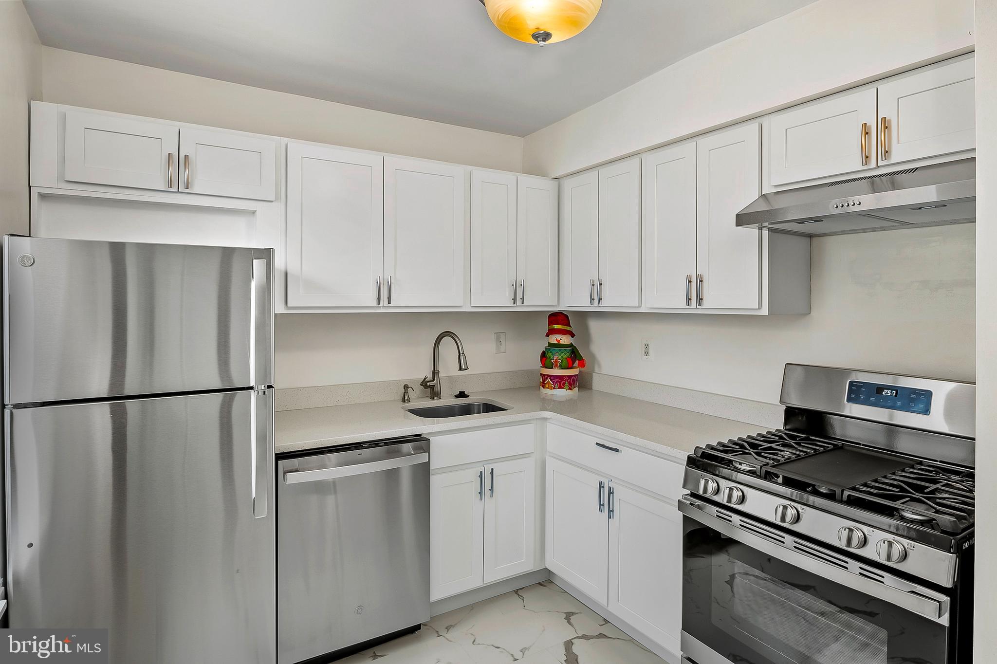 5870 Thunder Hill Road, Unit C2 Columbia, MD 21045 - Photo 6 of 23 a kitchen with stainless steel appliances granite countertop a sink stove and refrigerator