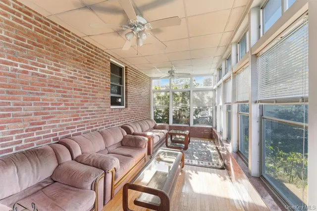 a living room with furniture and a floor to ceiling window