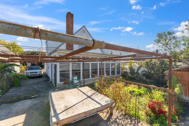 a view of a swimming pool with a patio and a yard